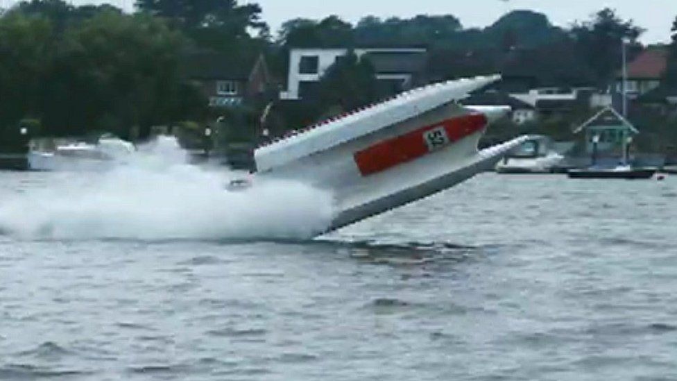 Powerboat flipping over in the water