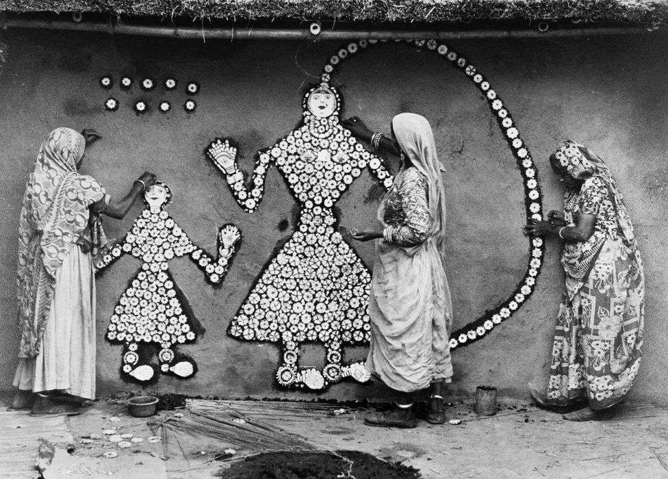 This photograph of Haryanvi women creating a Sanjhi mural painting, was made in the year 1977,