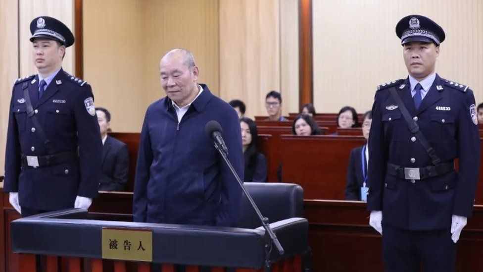 Xu Guojun, former head of a Bank of China sub-branch in Guangdong province, stands trial.