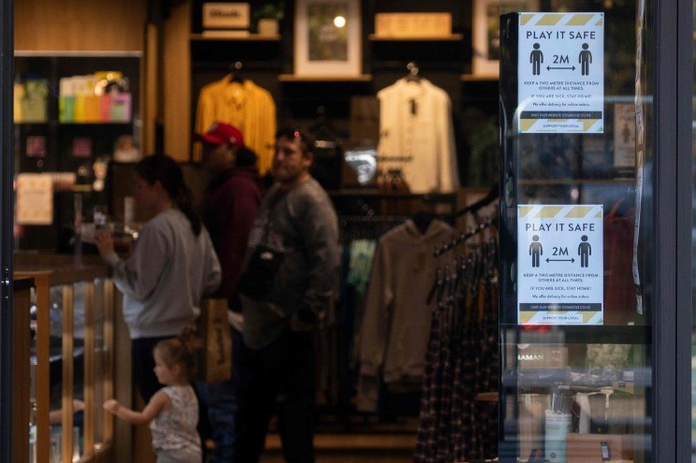 Posters promoting social distancing are displayed in a shop window in Christchurch on 14 May, 2020
