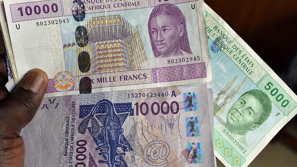 This photo taken on April 9, 2016 in a N'Djamena, Chad, shows CFA banknotes of the CFA currency issued by the Central Bank of West African States (Banque Centrale des Etats de l'Afrique de l'Ouest, BCEAO) and used in the eight west African countries which share the common West African CFA franc currency.