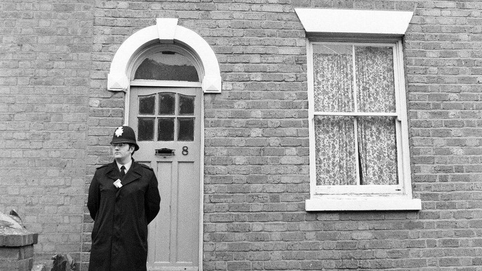 Officer outside the address in Gillam Street