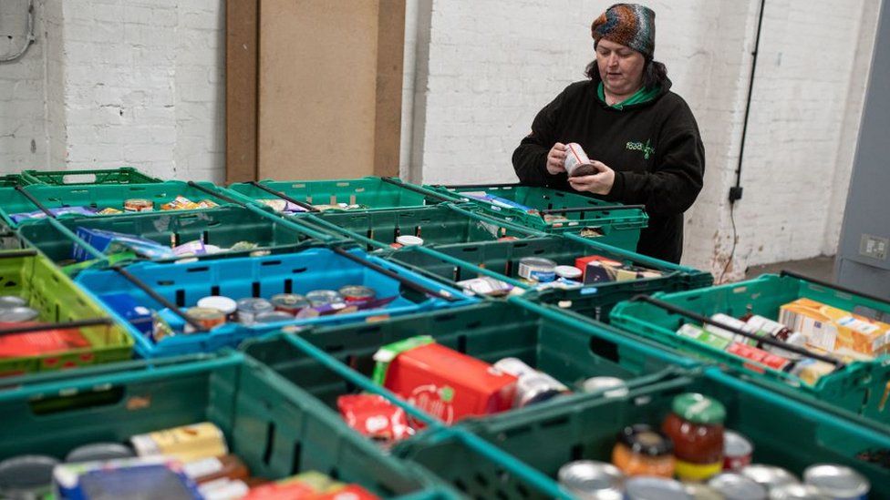 A member of staff at The Halo Centre, the central distribution point for donated items to be distributed to the Coventry Foodbank network