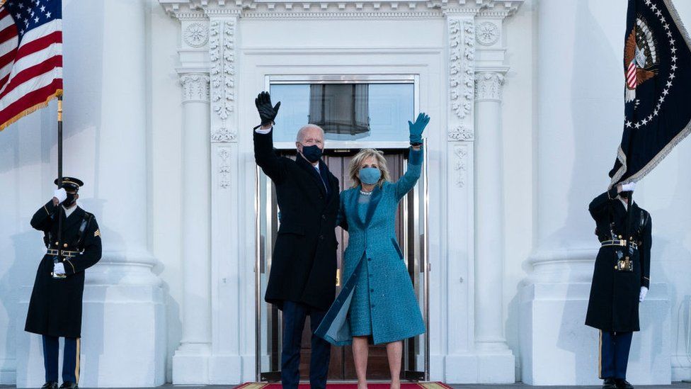 president biden with his wife dr jill biden waving outside the white house