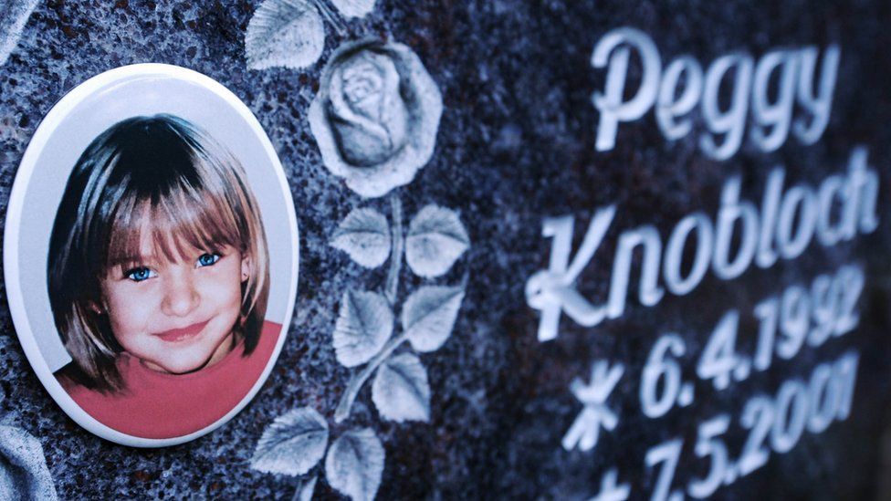 a photograph of a little blonde haired-blue-eyed girl on a grave headstone reading Peggy Knobloch 1992-2001