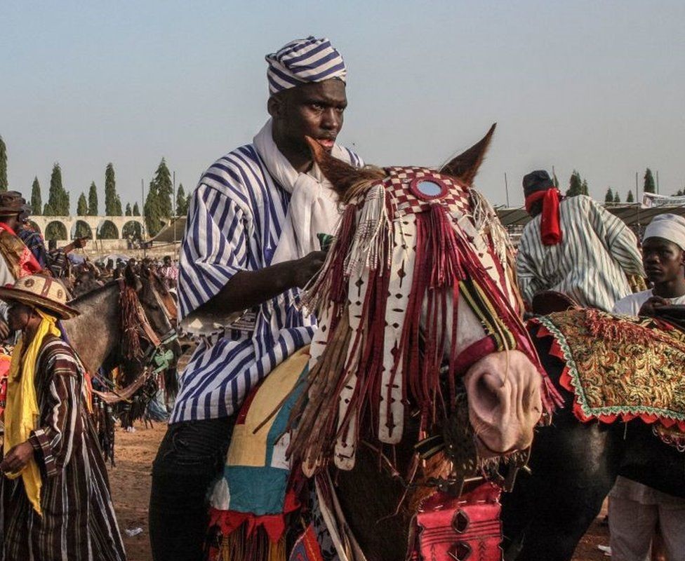 Horsemen are seen during a parade in Sokode, Togo, on January 14, 2023 during the celebrations for the Gaani Festival. - The seven centuries old traditions of the Gaani Festival, an annual two-days celebrations of joy and victory, are held in Togo, Benin and Nigeria