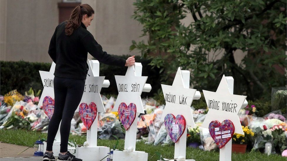 A woman reacts at a makeshift memorial outside the Tree of Life synagogue following Saturday's shooting