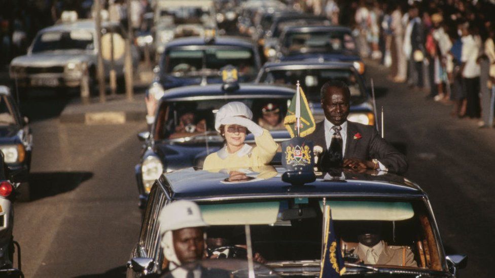 The Queen alongside President of Kenya Daniel arap Moi (1924-2020) in the motorcade after her arrival in Nairobi, Kenya, 10th November 1983. Prince Philip and Queen Elizabeth II are on a four-day State Visit to Kenya