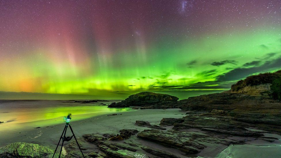 Aurora Australis lights up the sky over Brighton Beach in Dunedin, New Zealand