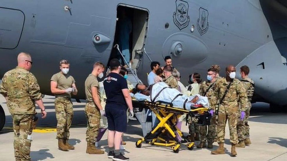 US forces take a mother and new born baby for medical attention after the women gave birth on an evacuation flight from Afghanistan