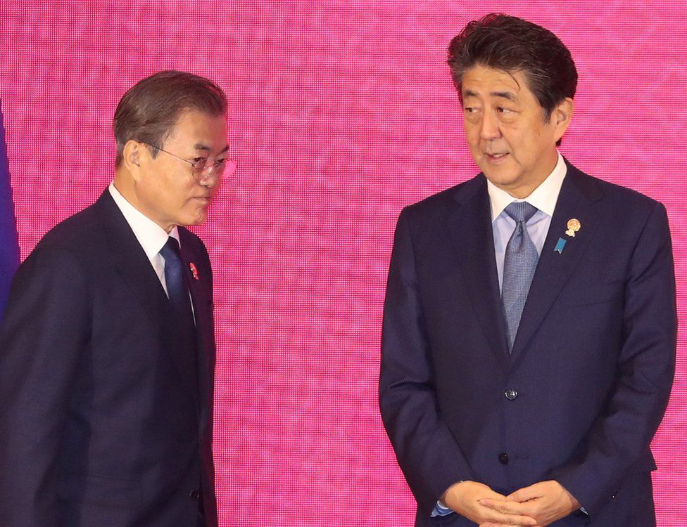 South Korean President Moon Jae-in walks past Japanese Prime Minister Shinzo Abe in Bangkok, Thailand, November 4, 2019