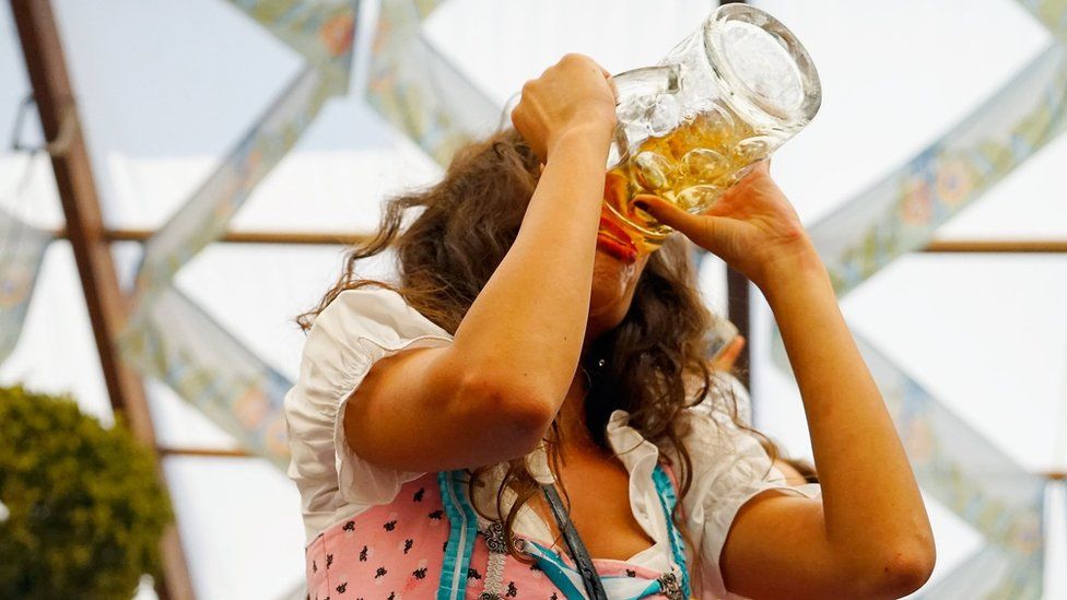 A young woman drinks beer at Hofbraeuhaus beer tent on the opening day of the 2015 Oktoberfest on September 19, 2015 in Munich, Germany