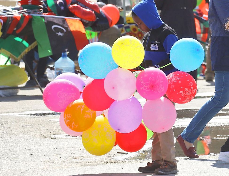 A boy selling balloons to celebrate in Martyrs Square, Tripoli, Libya - Saturday 17 February 2019