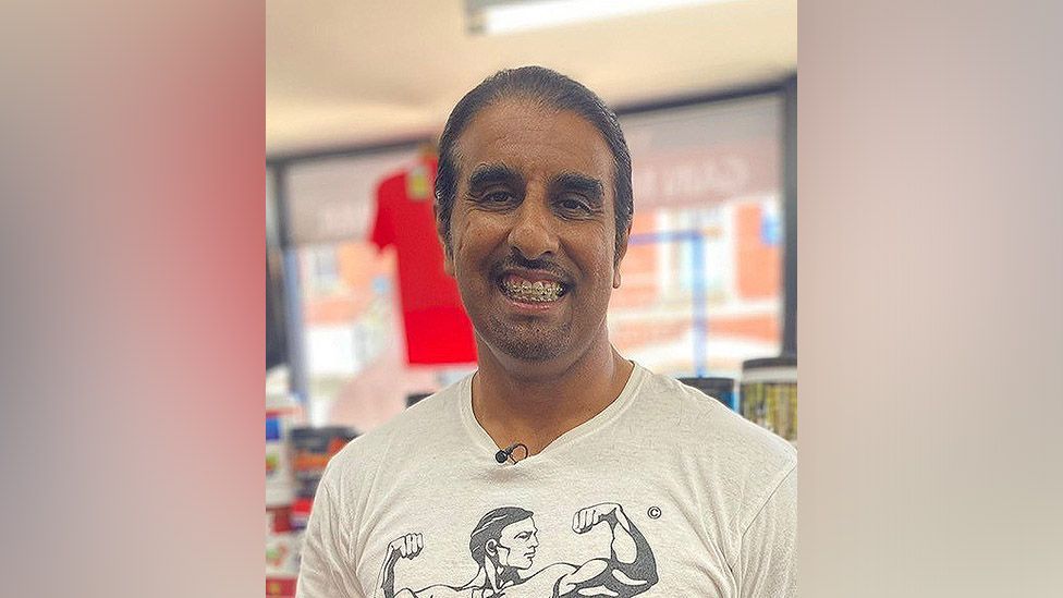Abaid 'Ice' Hussain smiling wearing a body builder T-shirt