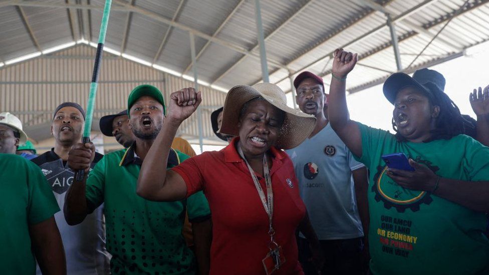 Mineworkers demonstrate at the entrance of the Gold One Modder East operation mineshaft in Springs on October 25, 2023.