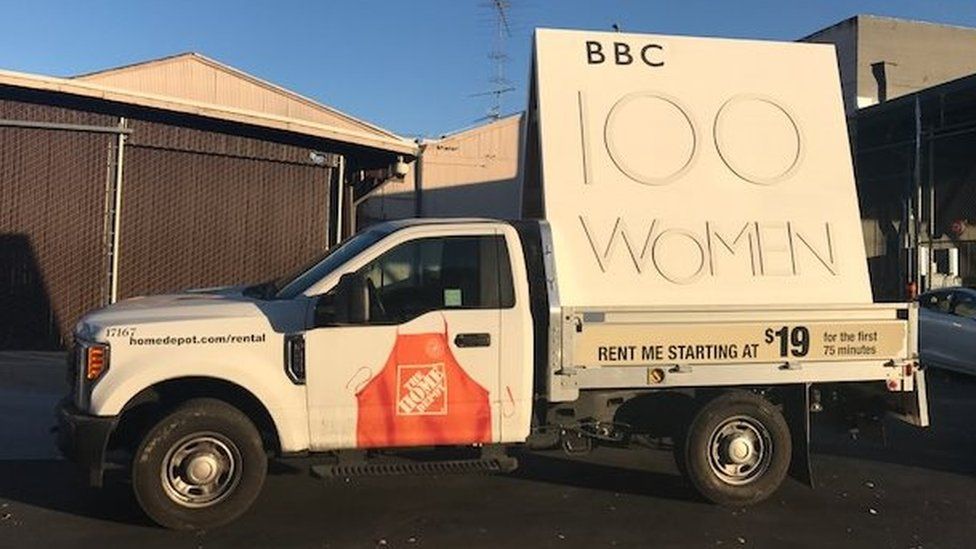 Pick-up carrying BBC 100 women placard