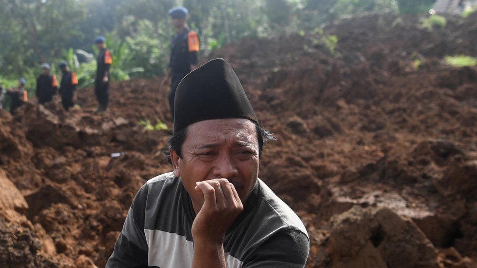 A man reacts as rescuers look for victims at an area affected by landslides after Monday's earthquake hit in Cianjur, West Java province