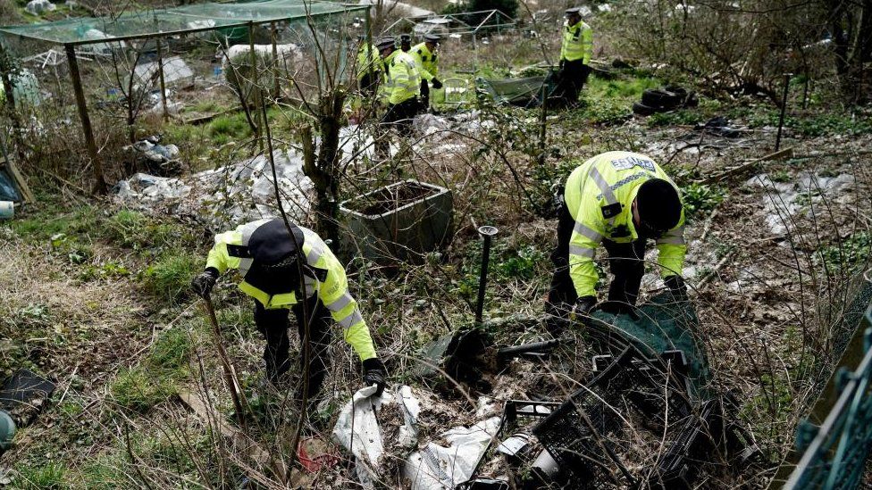 Police officers searching allotments in Sussex