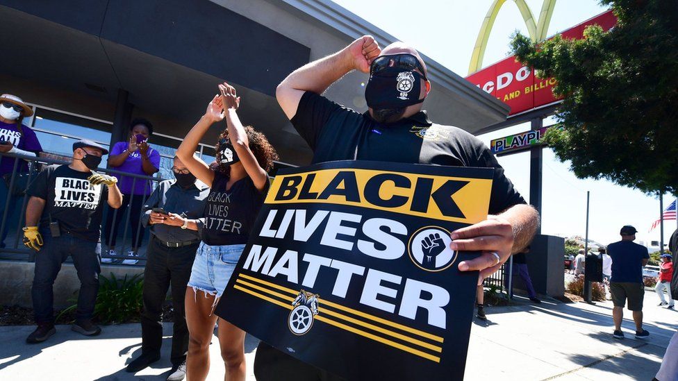 Activists protest in front of a McDonalds in Los Angeles, California, on July 20, 2020 during a Strike For Black Lives rally.