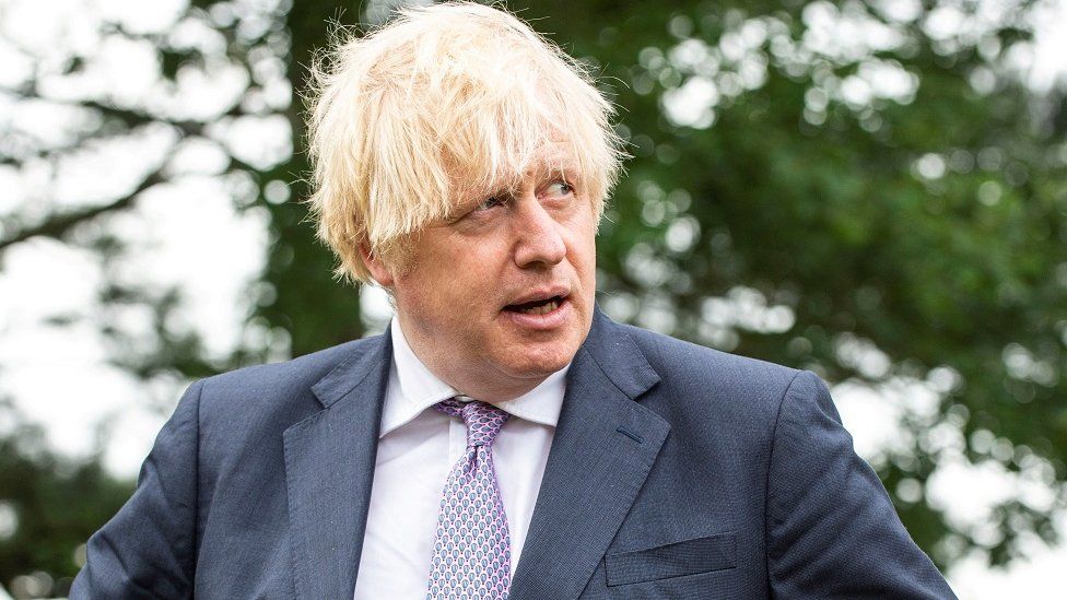 British Prime Minister Boris Johnson looks on during a visit to Surrey Police headquarters to coincide with the publication of the government"s Beating Crime Plan, in Guildford, Surrey, Britain