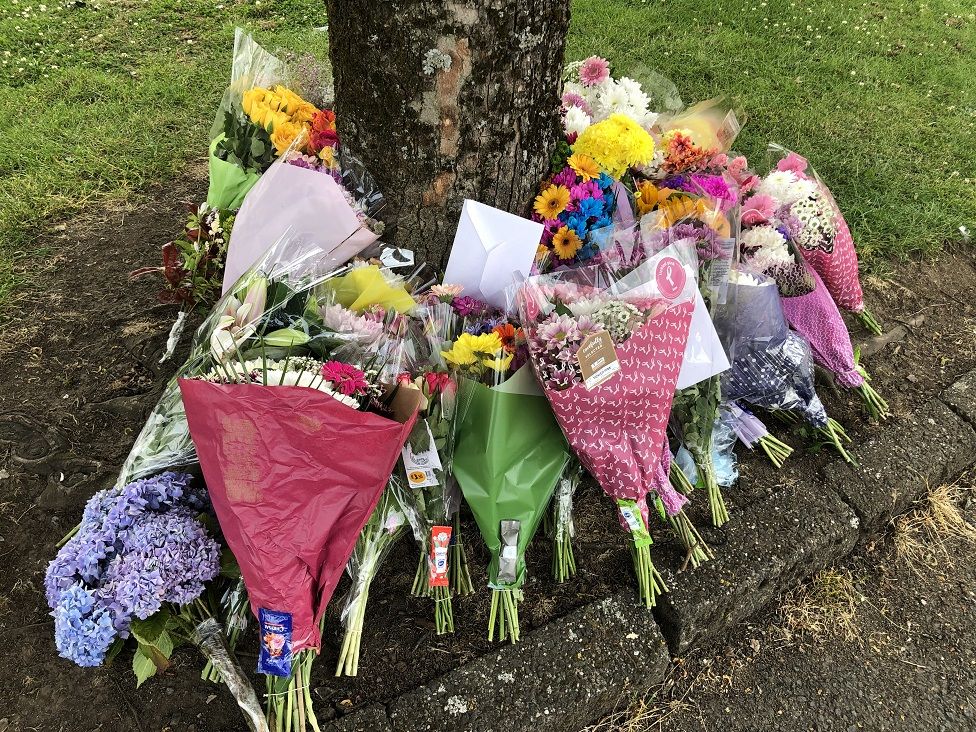 floral tributes at site of alleged hit and run