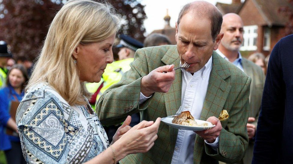 The Duke of Edinburgh tasting a coronation chicken pie
