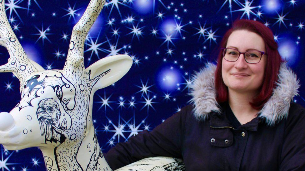 Artist Lydia Hartley with a painted reindeer