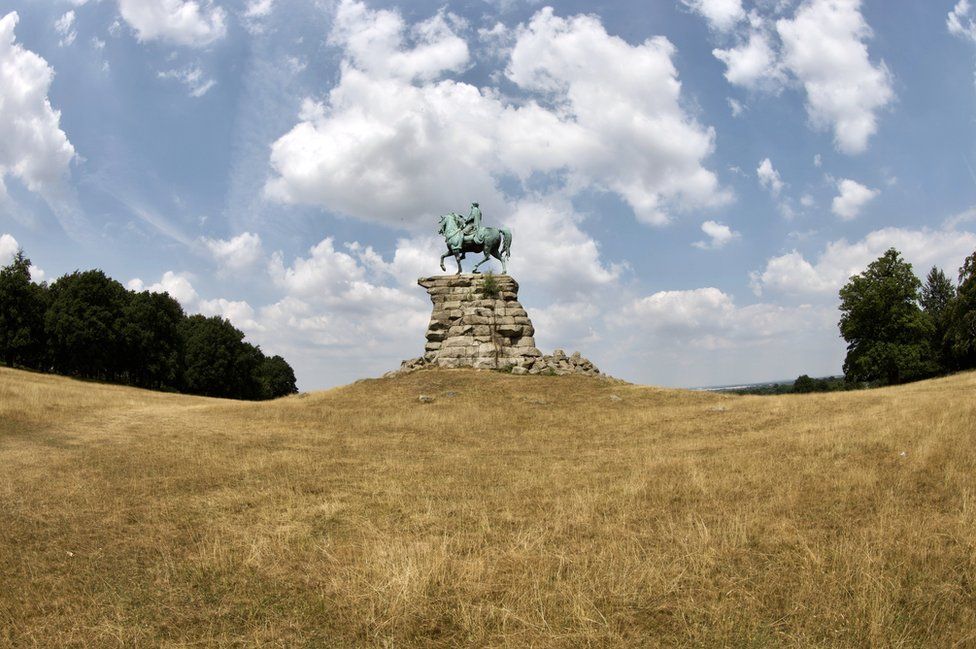 Parched grass at Snow Hill in Windsor Great Park by the Copper horse on a hot day.