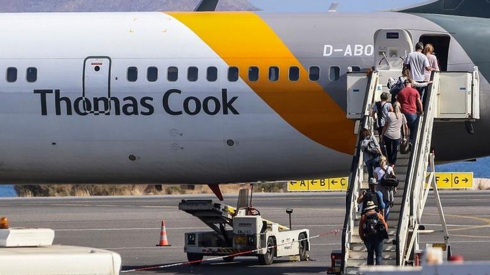 Tourists board a Thomas Cook plane at the airport of Heraclion, Crete