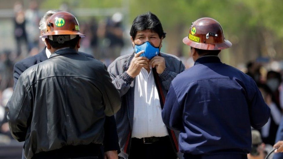 Former Bolivian President Evo Morales holds his face mask as he returns to his home country from exile in Argentina, at the border town of Villazon, Bolivia, November 9, 2020.