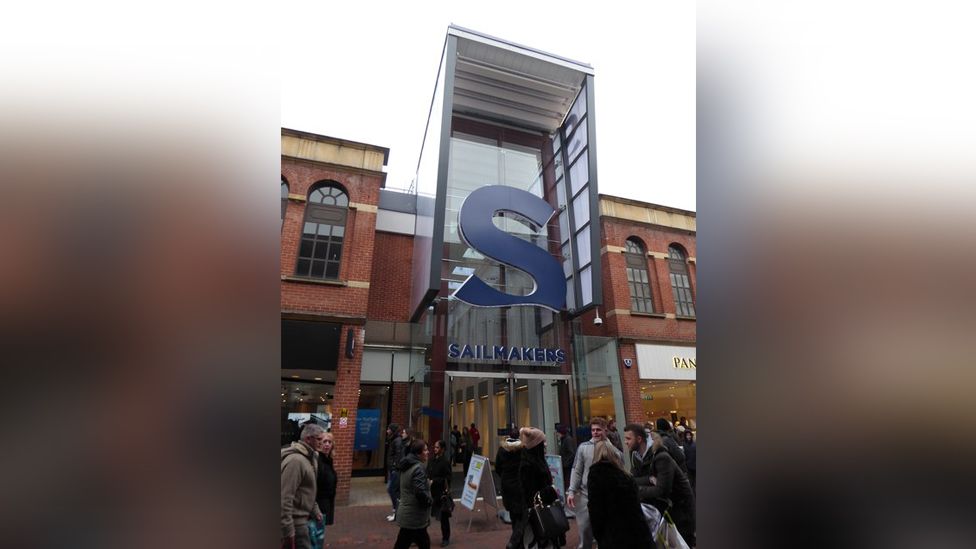 Entrance to Sailmakers shopping centre, Ipswich, with people walking past