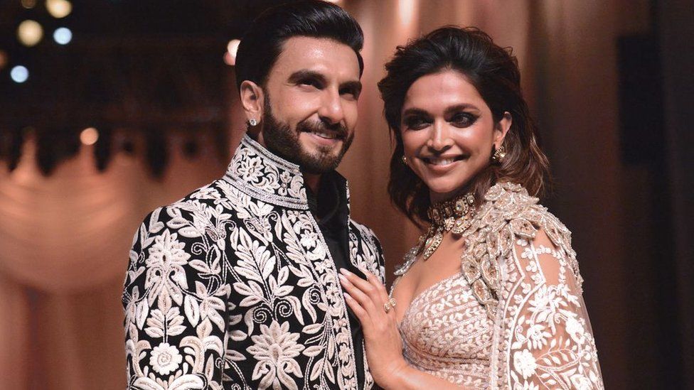 In this picture taken on July 29, 2022, Bollywood actors Ranveer Singh and Deepika Padukone walk the ramp for Mijwan Welfare Society and fashion show by designer Manish Malhotra in Mumbai.