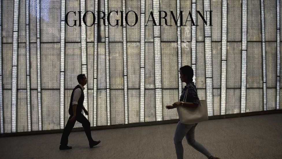 People walking past a store of top Italian designer Giorgio Armani in Hong Kong