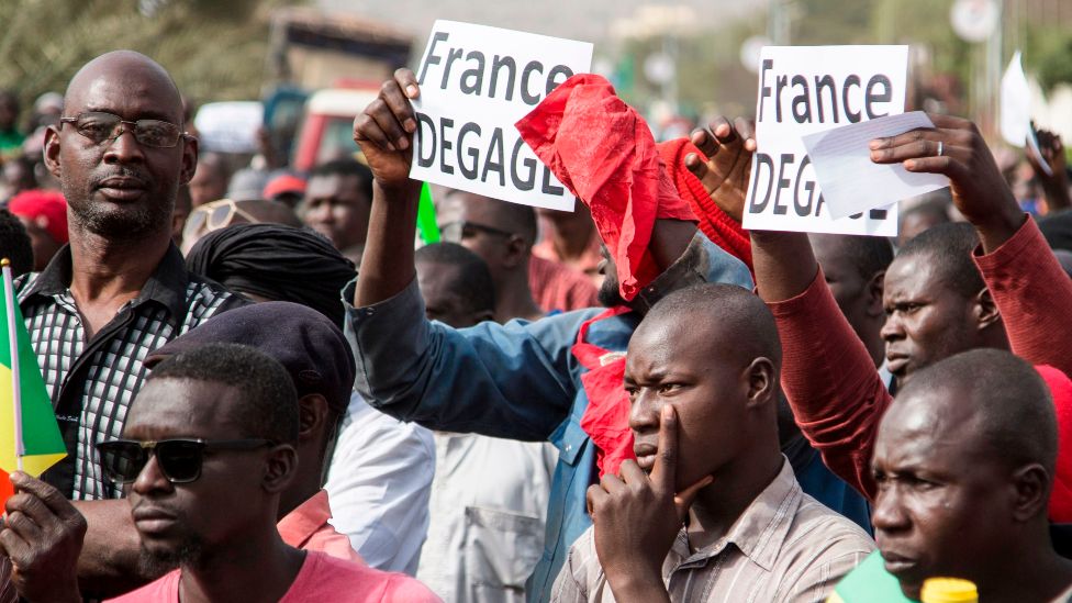 People hold signs that read in French: "France get out" during a protest against French and UN forces based in Mali in Bamako - 10 January 2020