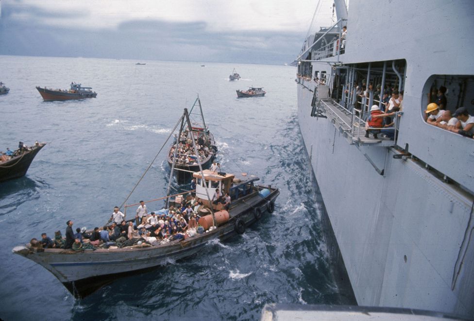 South Vietnamese refugees in boats approach a US warship to seek refuge, April 1975