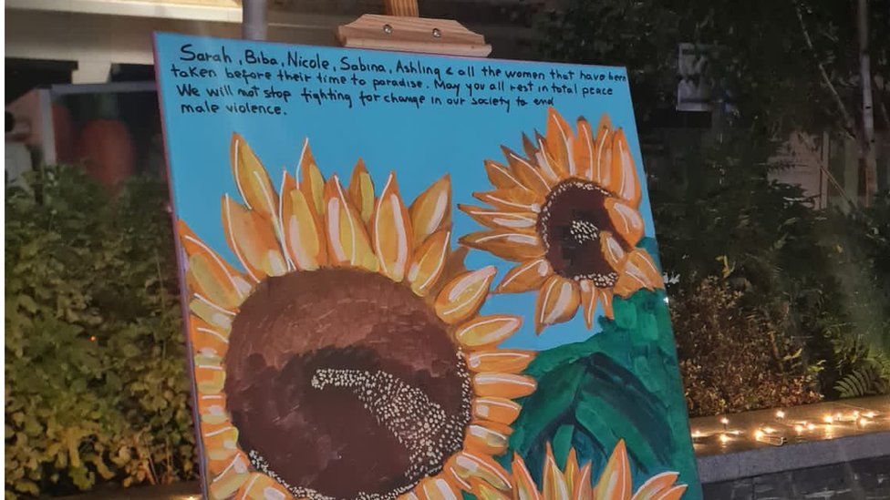 A message left at the vigil on a canvas painting of sunflowers