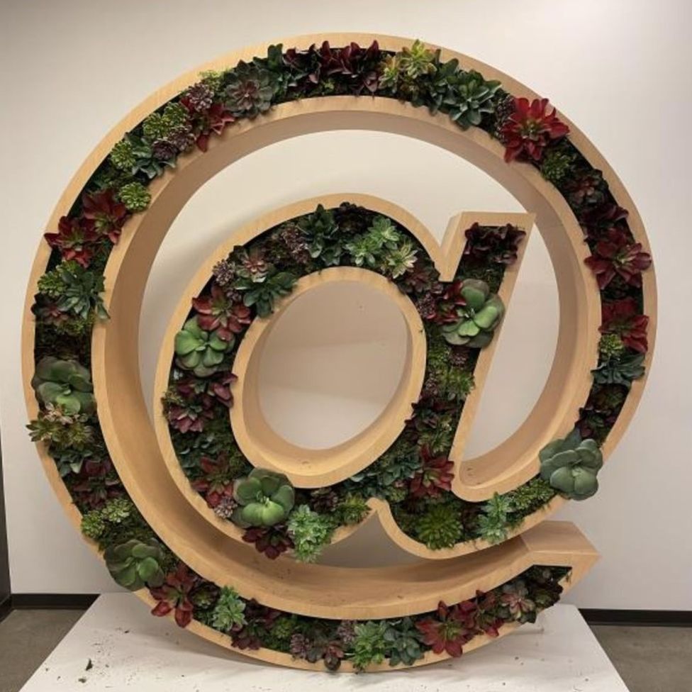 A planter shaped like the @ symbol