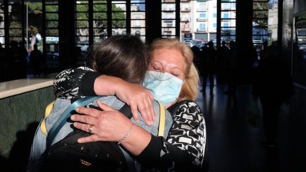 A mother and daughter embrace after the arrival of the first high-speed train connecting Turin and Reggio Calabria