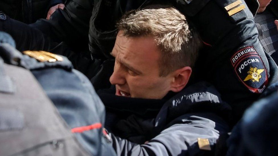Police officers detain anti-corruption campaigner and opposition figure Alexei Navalny during a rally in Moscow