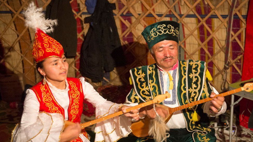 Father and daughter performing traditional Kazakh songs with Kazakh dombras