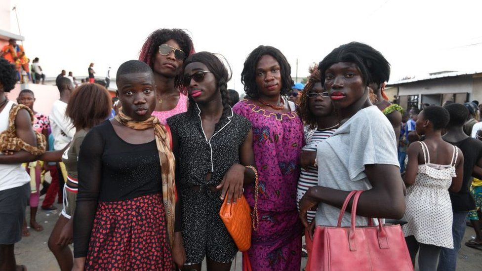 Men from the ethnic southeastern Aboure people, dressed up as women, pose for a photograph during the 38th Edition of the POPO Carnival of Bonoua, 50 kms east of Abidjan, an annual festival held by the Aboure people on April 14, 2018.