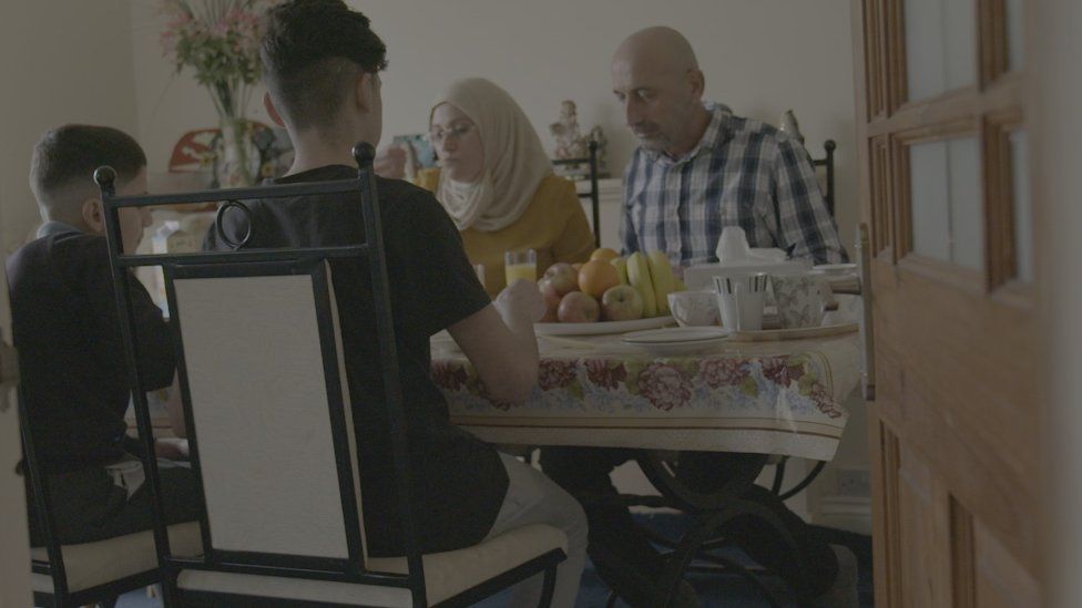 Khaled Muha's and his family eat tea