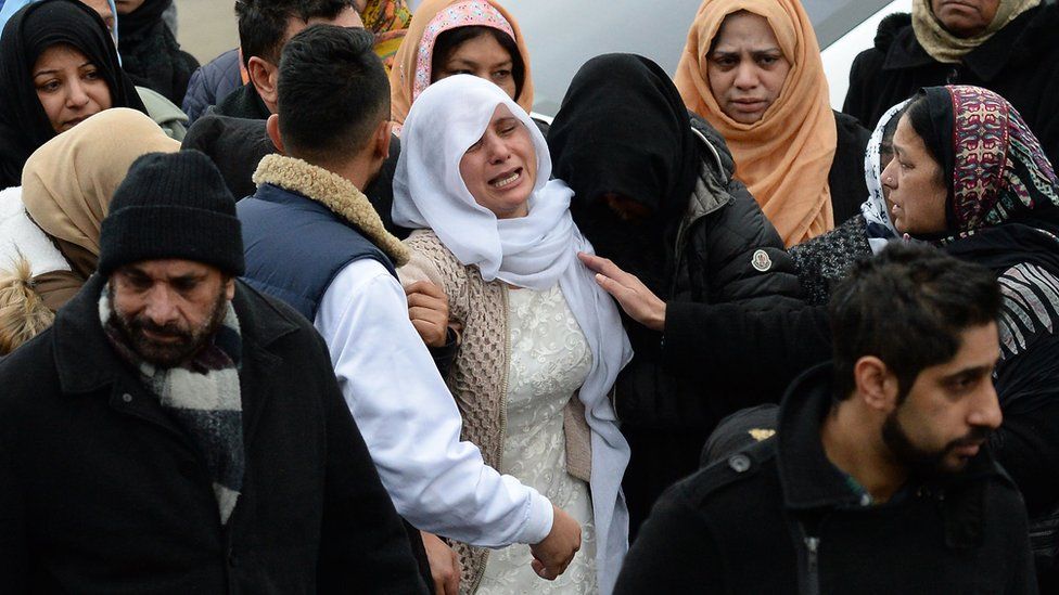 The mother of Mohammed Yassar Yaqub, is comforted at Masjid Bilal Huddersfield
