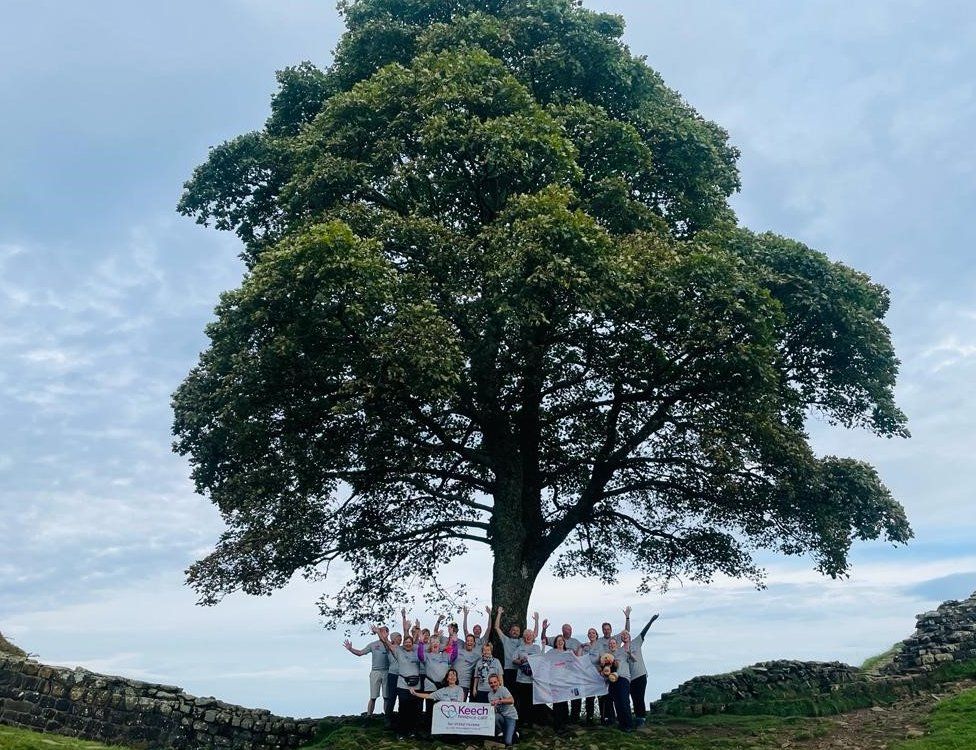 A group pose under the tree