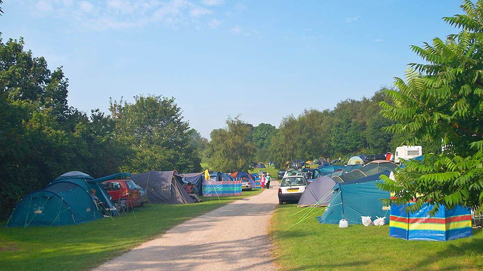 Camp site with multiple family-size tents in Bath