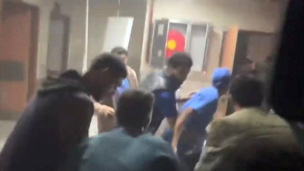 A screengrab from footage taken at Nasser hospital shows people, including in medical scrubs, appearing to run through a corridor