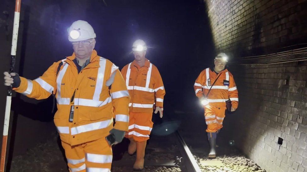 Engineers in railway tunnel