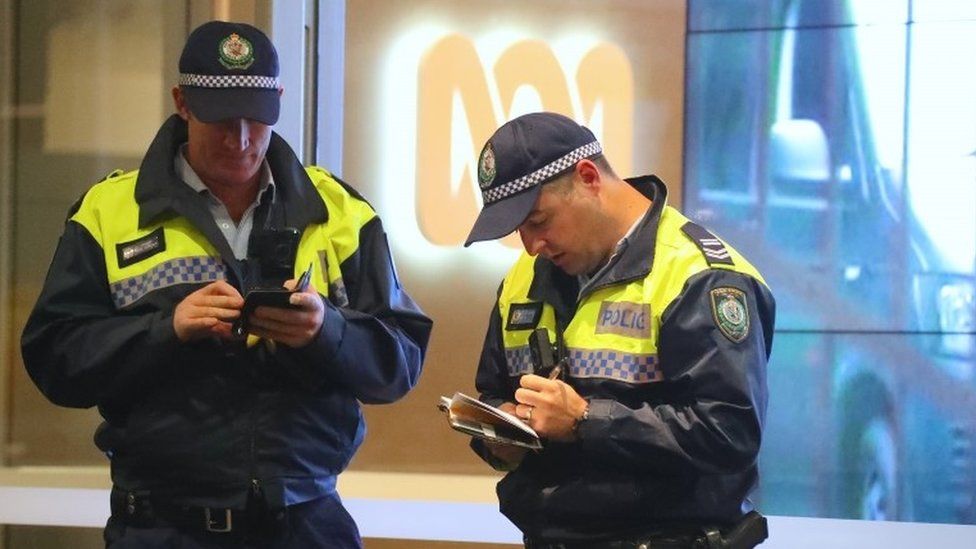 Policemen outside ABC's offices