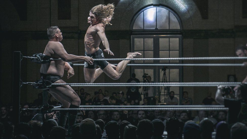 Matt Riddle attacks Walter during a wrestling match