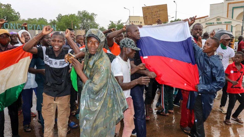 Supporters of the coup outside the National Assembly showing people holding Niger and Russian flags - Thursday 27 July 2023